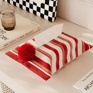 Red and white striped fabric tissue box cover with fluffy pom pom for home decor