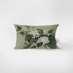 Detail shot of rectangular flannel pillow featuring vintage botanical art with white flowers.