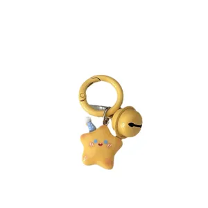 Cute star keychain with bell and yellow round buckle, sweet cartoon pendant for bag decor.