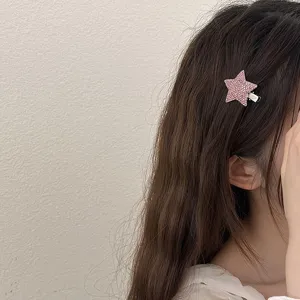 Sparkling pink rhinestone star hairpin, detail view of cute hair accessory for styling.