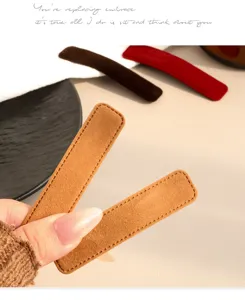 Close-up view of velvet rectangular hair clip, showing soft texture and delicate edge stitching.