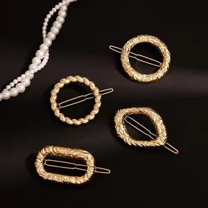 Detailed close-up of elegant gold metal geometric hair clips and pins for women's stylish hair styling.