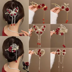 Close-up details of the elegant red velvet flower metal hair clips with pearl tassels.