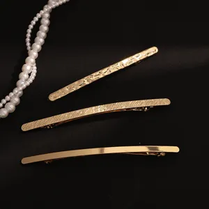 Elegant gold hair clips for women, metal barrettes with stylish textures and spring design.