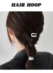 Minimalist metal hair clip detail, sleek silver ponytail holder for elegant daily hairstyles.