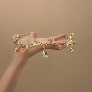 Gold leaf teardrop tiara detailed shot, crystal bridal headband for elegant princess look.