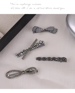 Detailed close-up of elegant rhinestone pearl hair clips, sparkling side and top hair accessories.