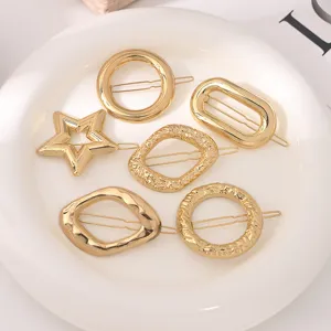 Golden geometric metal hair clips set, featuring round and star shapes for chic hairstyles.