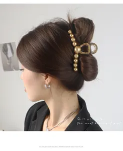 Detail shot of the elegant pearl hair claw clip, showing exquisite craftsmanship and design.