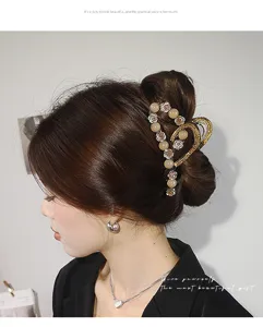 Close-up detail shot of elegant pearl rhinestone hair claw clip, stylish back head design.
