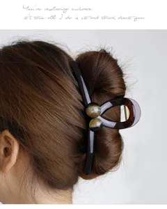 Large hair claw clip detail shot, showing the elegant tortoiseshell pattern and secure grip.