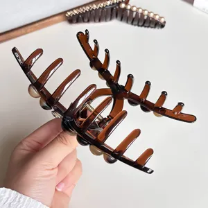 Large brown hair claw clip for thick hair, stylish aesthetic design, secure hold accessory.