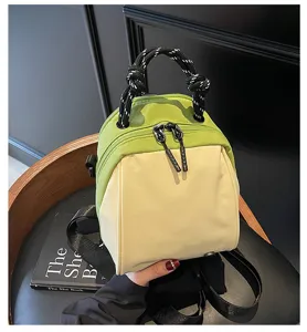 Compact colorblock mini crossbody bag with rope handles and stylish commuting design.