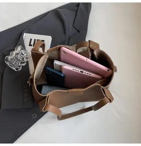 Stylish brown leather tote bag with large capacity, perfect for daily commuting and office.