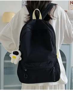 Sac à dos décontracté noir uni pour femmes, idéal pour les trajets quotidiens et l'école spacieux.