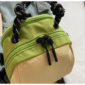 Detailed view of two-tone women crossbody bag with rope handle, stylish commuter shell bag.