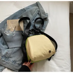 Minimalist two-tone canvas mini backpack, casual shell crossbody bag for women daily commute.