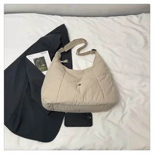 Minimalist beige puffer shoulder bag, large capacity lightweight crossbody tote for daily wear.