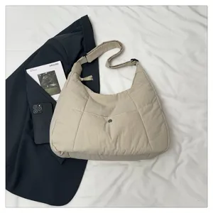 Beige quilted hobo shoulder bag detail shot, large capacity casual crossbody handbag.