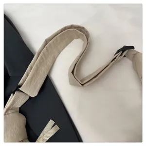 Detailed view of the casual crossbody bag adjustable shoulder strap and durable plastic buckle.