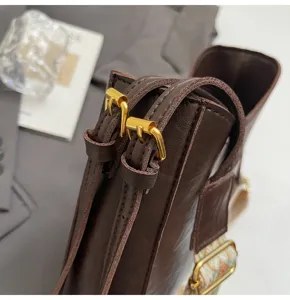 Brown leather women shoulder bag detail, stylish crossbody bag with gold hardware buckle.