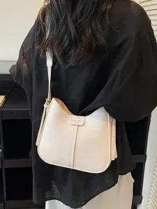 Minimalist beige shoulder crossbody bag for women, trendy leather saddle bucket bag everyday.