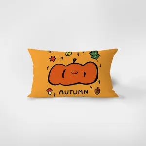 Close-up detail view of orange rectangular velvet throw pillow with cute autumn pumpkin graphic.