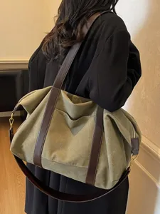 Large capacity canvas shoulder bag for women, stylish color block duffel and crossbody bag.