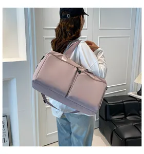 Detail shot of large capacity pink shoulder travel bag with durable fabric and front zipper pocket.