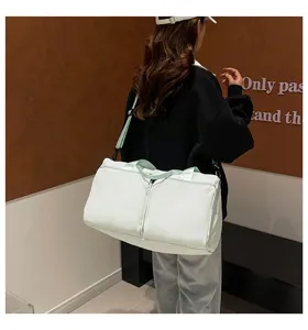 Large capacity solid color women travel duffel bag with shoulder strap for yoga and fitness.