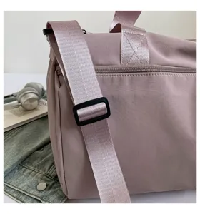 Detailed view of large capacity solid color nylon travel gym duffel bag with shoulder strap