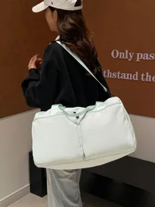 Large capacity solid color travel duffel bag for women, shoulder gym bag in light green.
