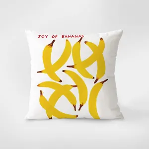 Decorative white throw pillow featuring artistic yellow bananas print and text. Soft cushion.