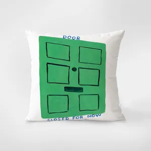 Detailed view of the artistic green door print throw pillow featuring playful text design.