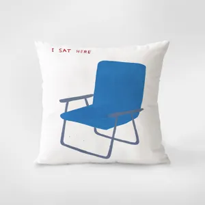 Minimalist white throw pillow with blue folding chair print and chic text for living room.