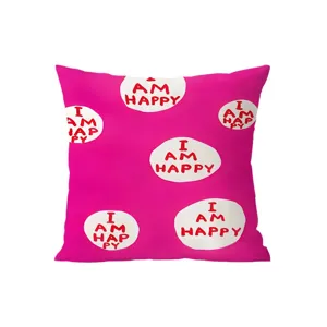 Pink decorative throw pillow detail, featuring creative text pattern, soft fabric cushion.