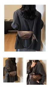 Details of stylish brown saddle bag for women, featuring a sleek crossbody design.