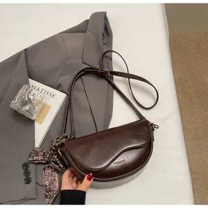 Dark brown leather saddle bag for women, retro half-moon crossbody shoulder bag with slim strap.
