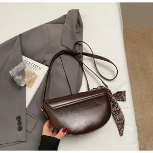 Stylish brown PU leather saddle bag for women, trendy underarm shoulder crossbody bag with scarf.