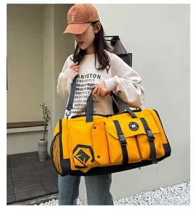 Large capacity yellow travel duffel bag detail view, multi-pocket gym sports shoulder bag.