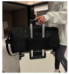 Detailed shot of large travel duffel bag mounted on luggage handle for commuting and trips.