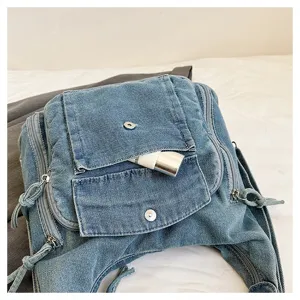 Close-up detail of stylish women denim canvas casual backpack bag with multiple pockets design.