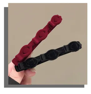 Close-up detail of velvet braided hair clips, showcasing soft texture and secure dual-color design.