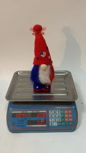 Detail view of the patriotic gnome doll with a star hat and plush beard on a digital scale.