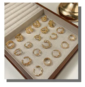 Detailed close-up of vintage gold open rings set, irregular minimalist alloy finger jewelry.