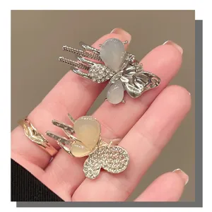 Detailed view of sweet butterfly hair clips with rhinestones, elegant side bang clips.
