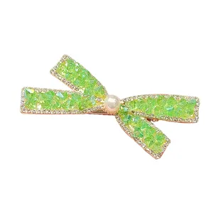 Elegant green rhinestone bow hair clip with a central pearl, ideal for stylish side bangs styling.