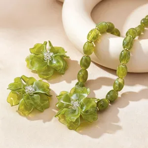 Detailed close-up shot of the elegant green flower resin necklace and matching earrings set.