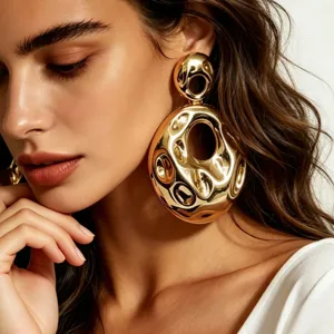 Close-up detail of oversized hammered gold earrings, minimalist avant-garde jewelry design.