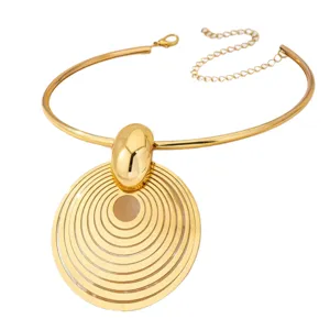 Retro gold metal statement choker necklace with large concentric circle pendant for women.